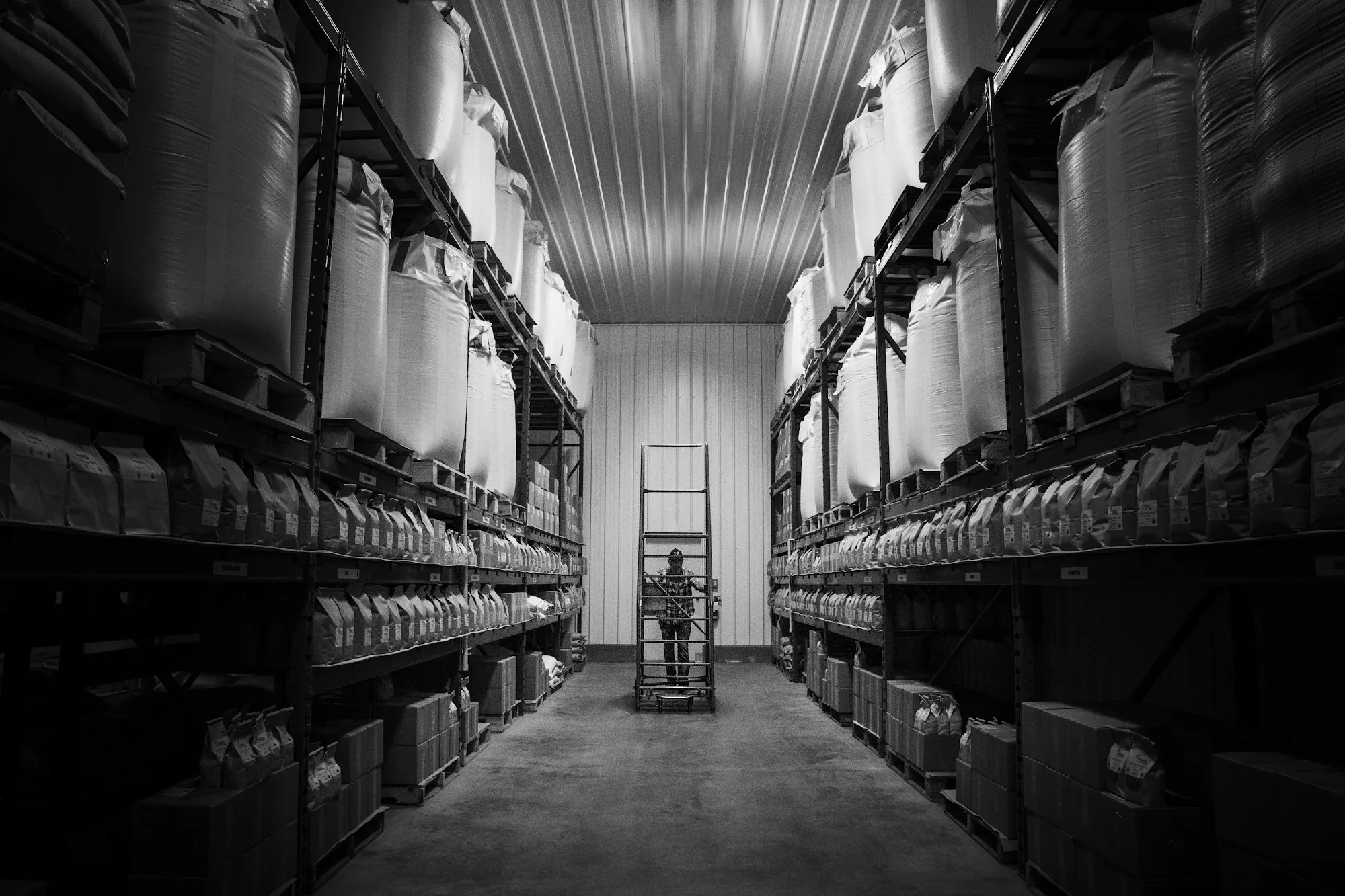 A long warehouse aisle lined with stock